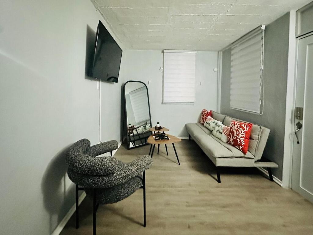 a living room with a couch and a chair at Gema del Mar, Vieques, PR in Vieques