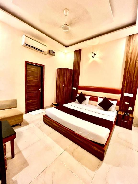 a bedroom with a large bed in a room at Hotel Wooodcrestt Zirakpur in Zirakpur