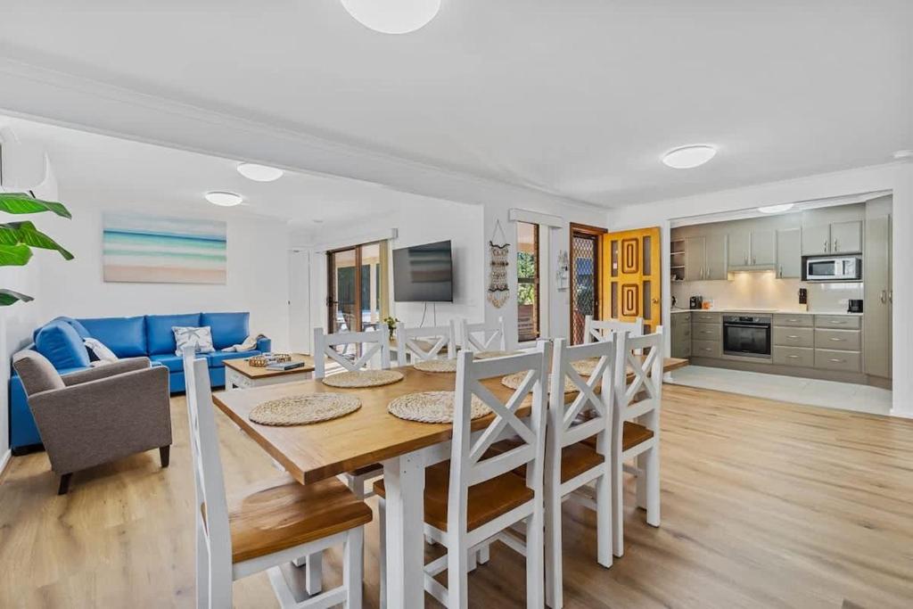 a dining room and living room with a table and chairs at Winnies on Sunpatch in Tomakin