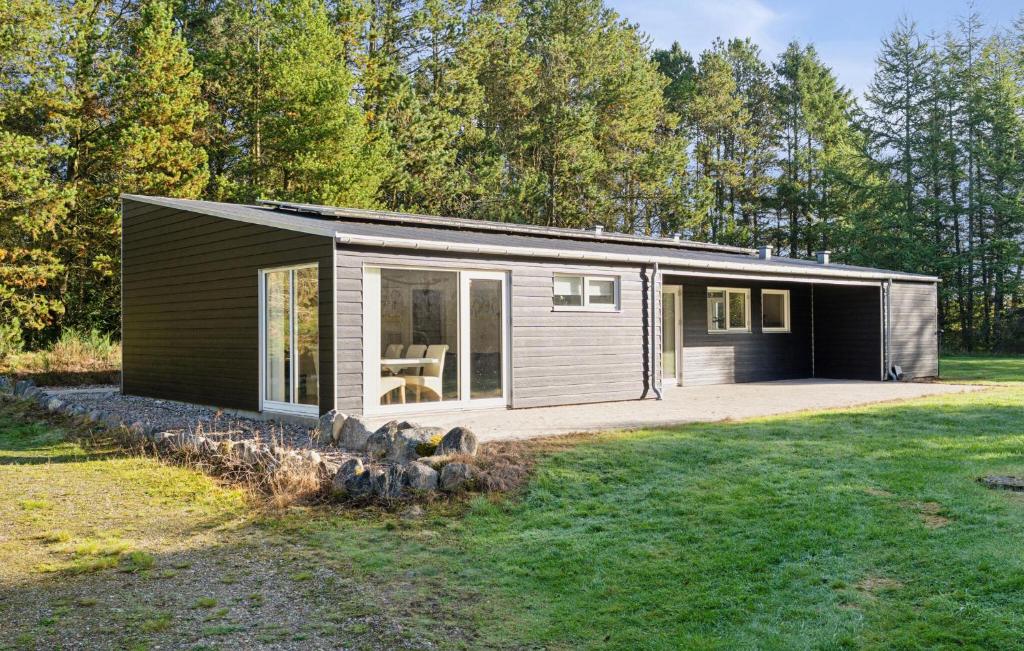 a small cabin in the woods with a yard at Awesome Home In Bording With Sauna in Korning