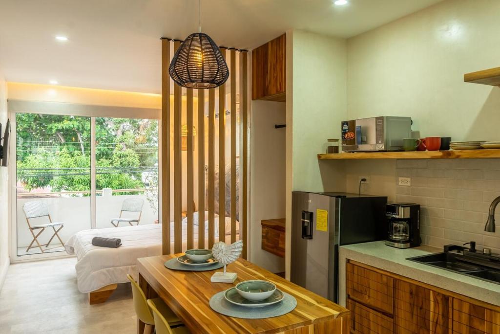 a kitchen with a table with plates on top of it at Japandi Las Islas in Puntarenas