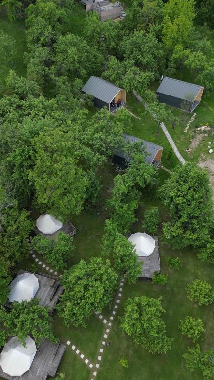 an overhead view of a park with trees and buildings at Tinutul Luanei Glamping Resort in Bozioru