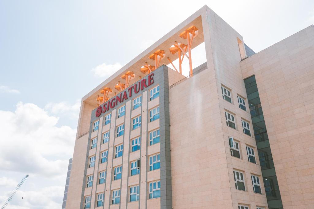 a building with a sign on top of it at Jeonju Signature Hotel in Jeonju