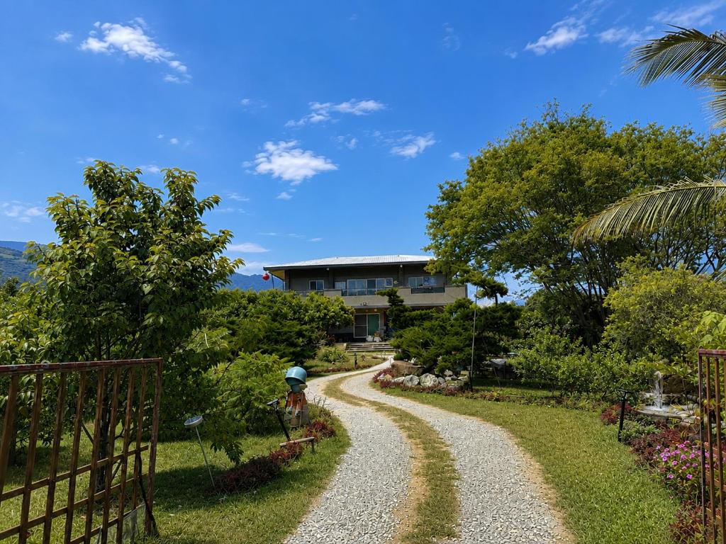 a house on a hill with a gravel road at Du Du Hao B&B in Yung-an-ts'un
