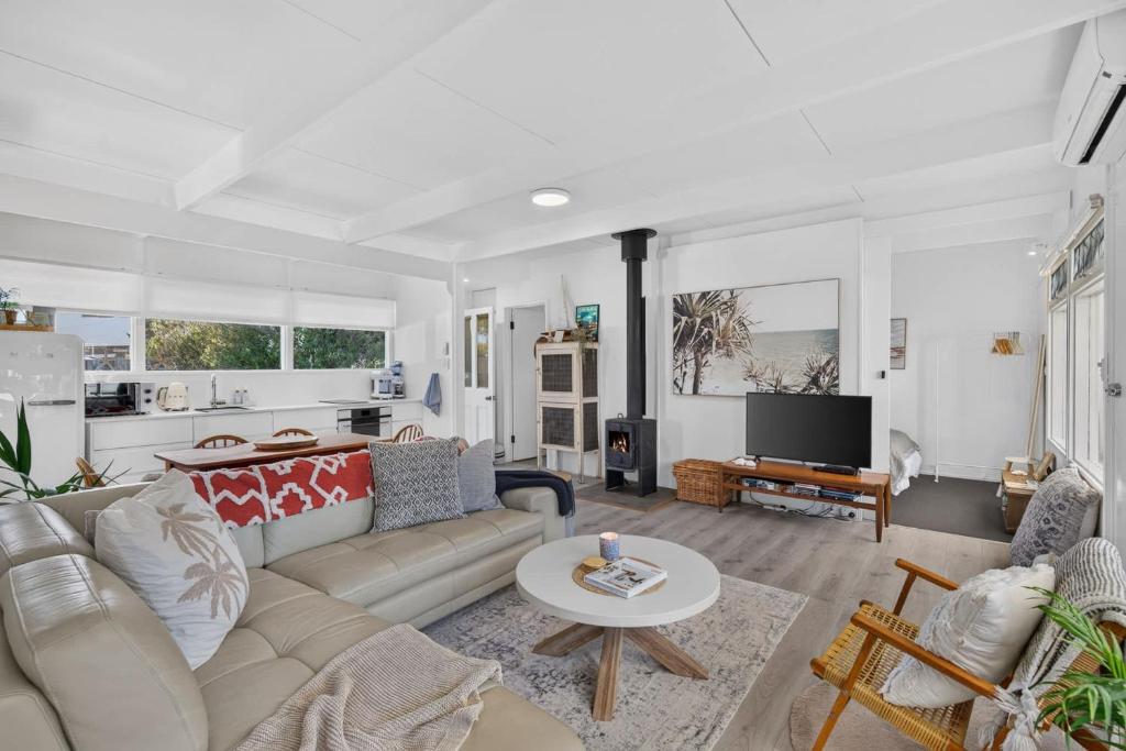 a living room with a couch and a table at River & Tide escape - On Galpin in Goolwa South