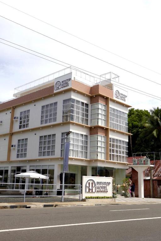 a building on the side of a street at Pitstop Mango Grove Retreat in Guimaras