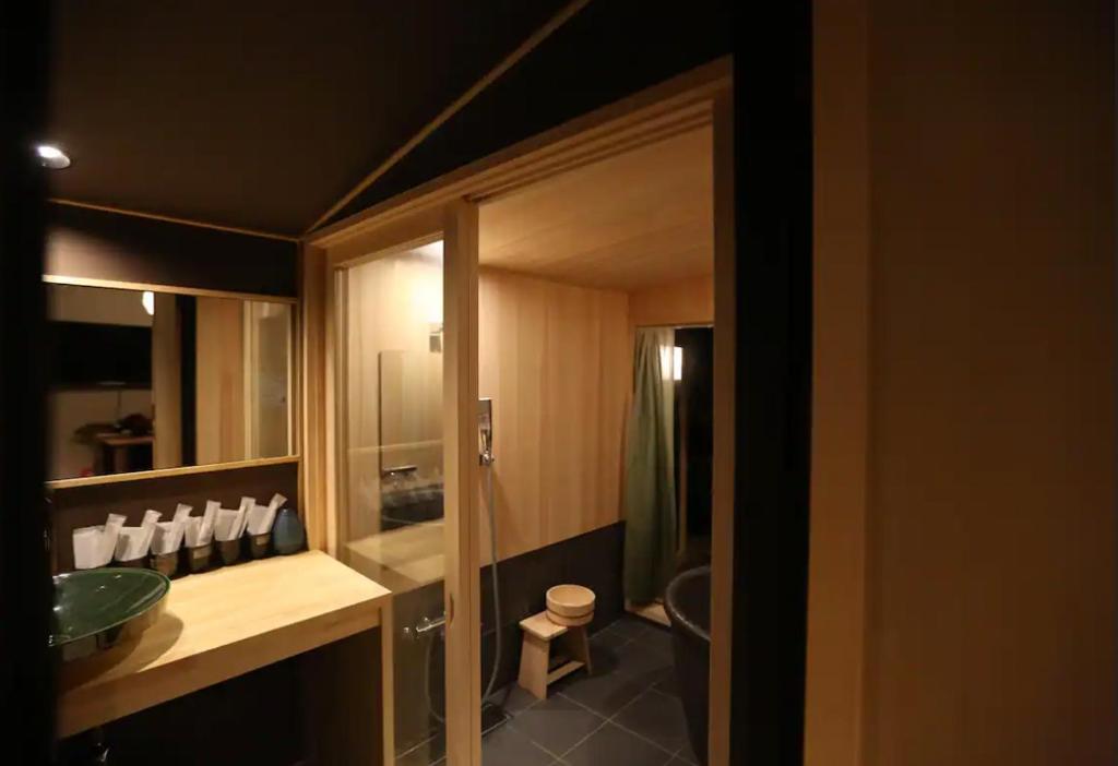 a bathroom with a sink and a toilet at Machiya Minami Omiya in Kyoto