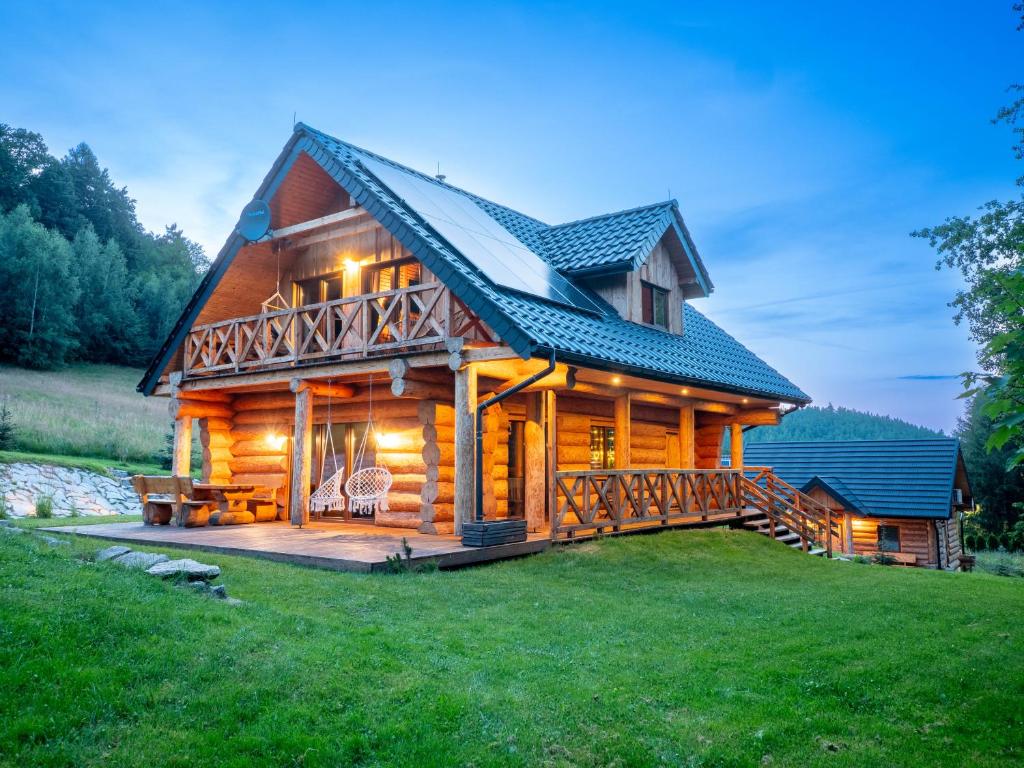 a large log cabin with a large deck at Chata Czego Dusza Pragnie in Zachełmie