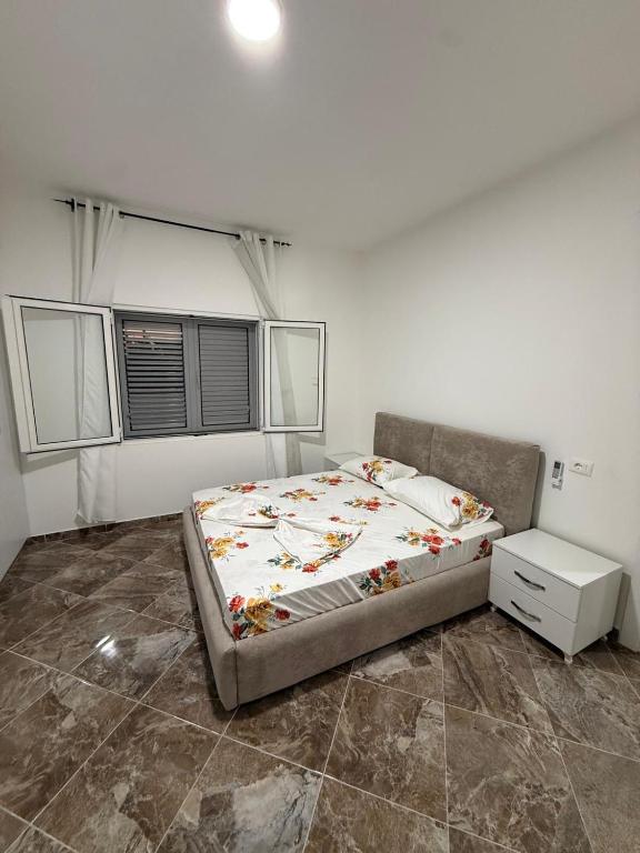 a bedroom with a bed in a room at Vila Muhadri in Kamëz