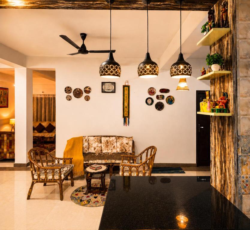 a living room with a table and chairs at Whispering Meadows Luxury 3BHK Villa in Shimla
