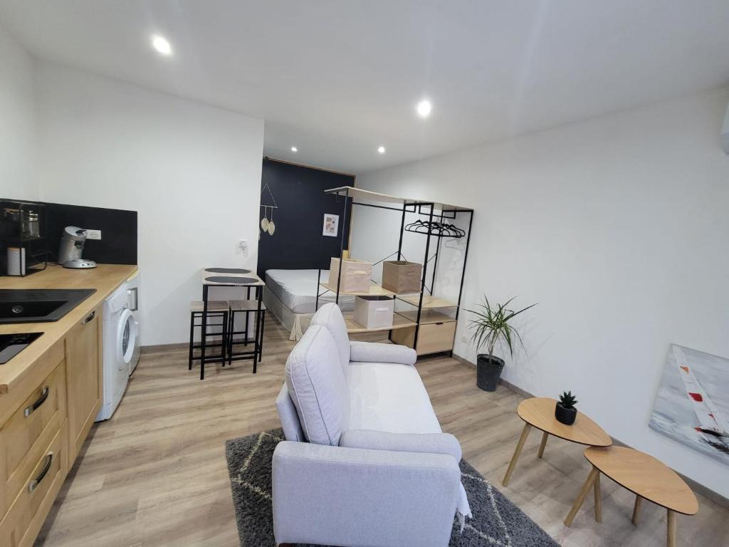 a living room with a white couch and a table at STUDIO A 2 MN DE L A75 in Usclas-lʼHérault
