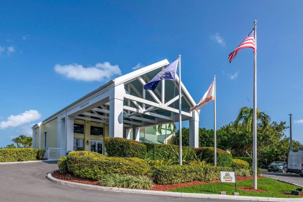 two american flags in front of a building at Bluegreen Vacations Hammocks at Marathon, Ascend Collection Resort in Marathon