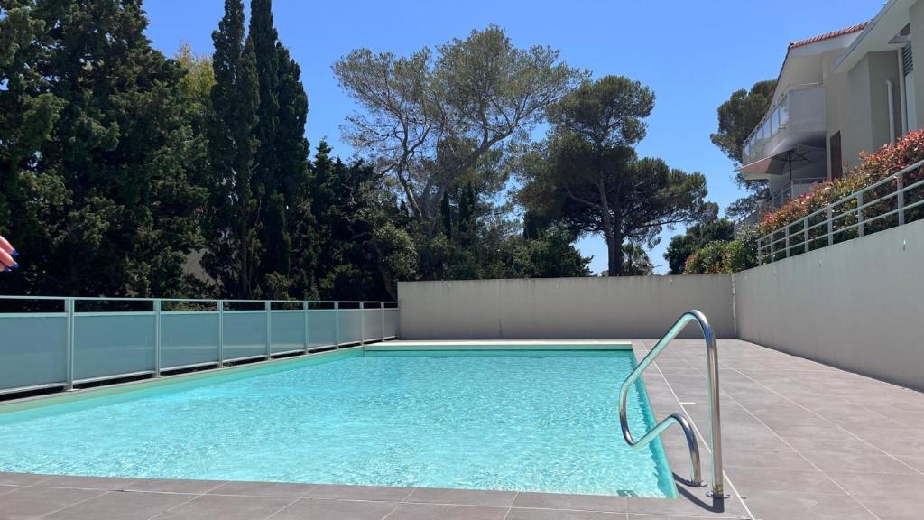 a swimming pool on the side of a house at Les Calanques de Saint-Aygulf in Saint-Aygulf