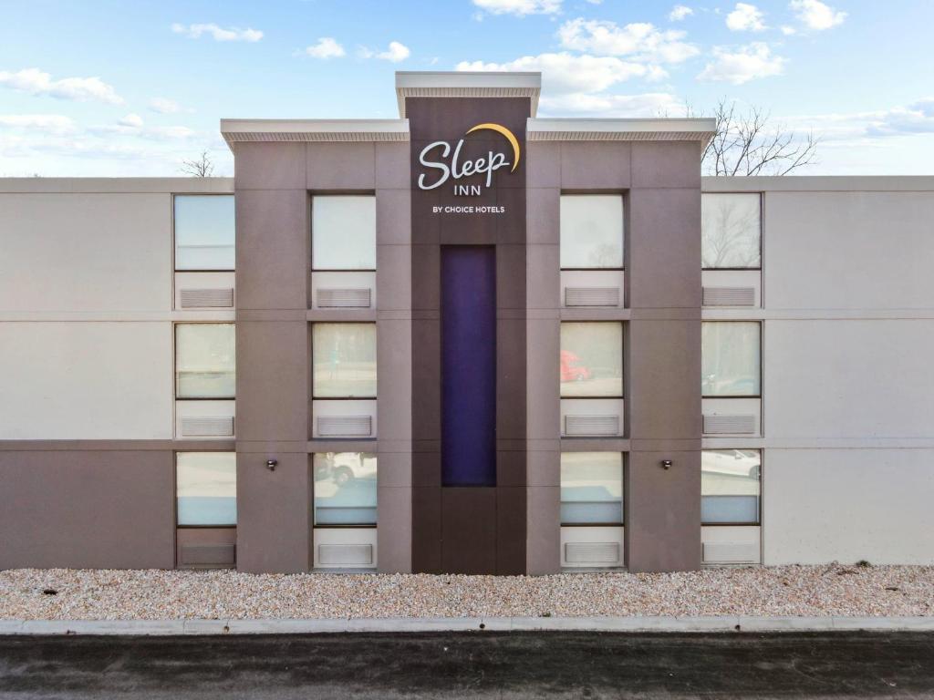a building with a sign on the side of it at Sleep Inn Chambersburg in Chambersburg