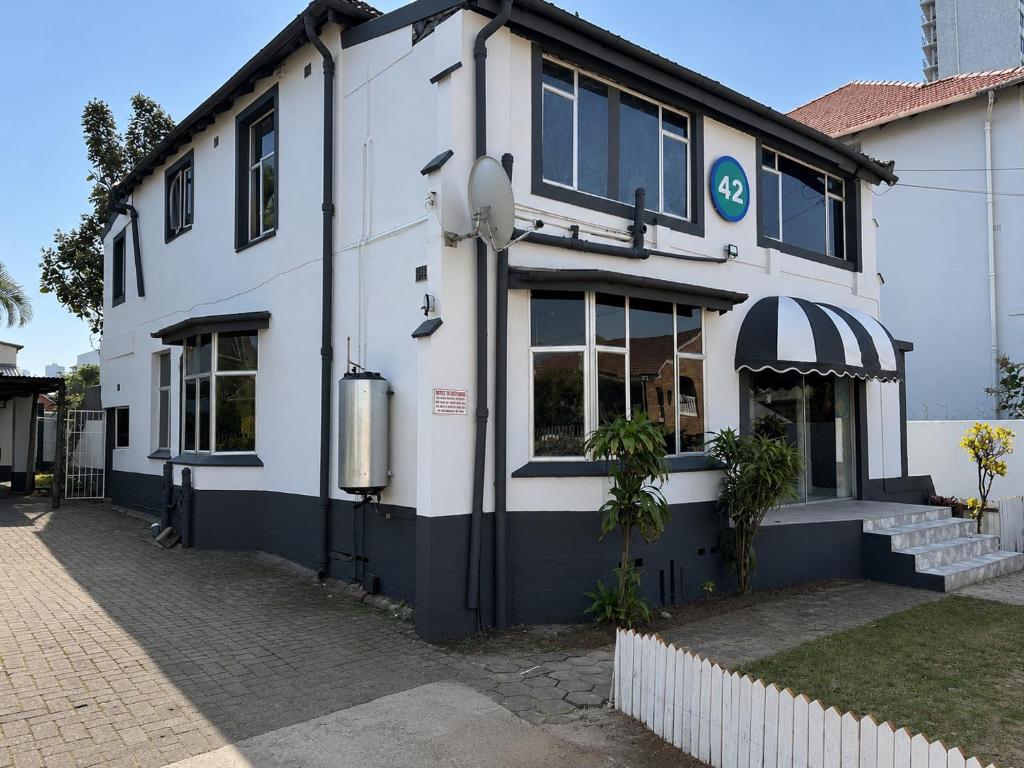 a white building with a blue and white facade at 42 On Canterbury in Durban