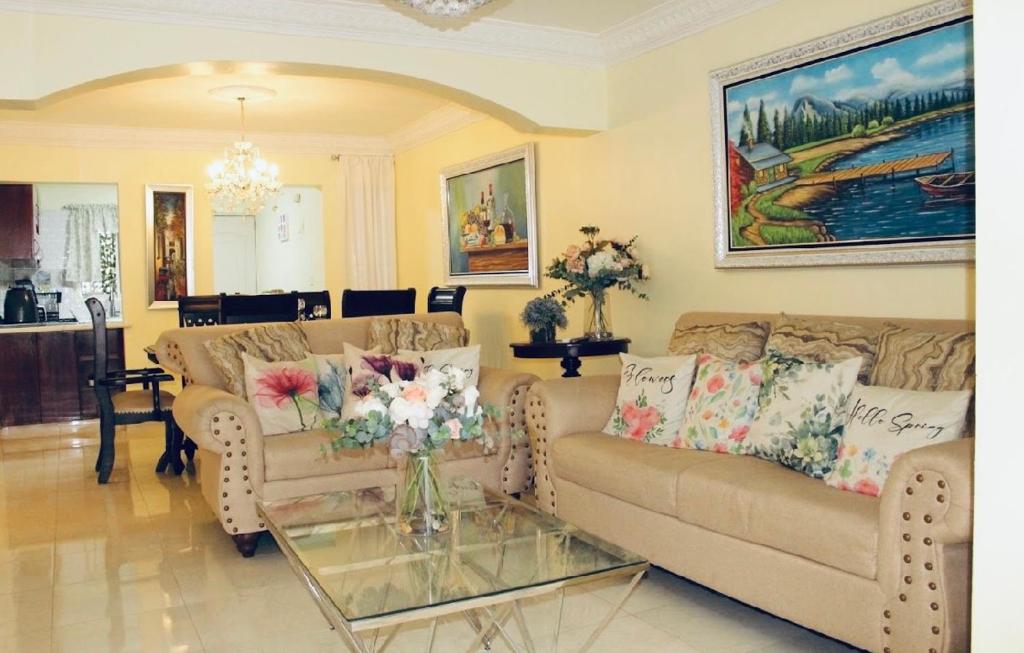 a living room with two couches and a glass table at Confortable in San Isidro