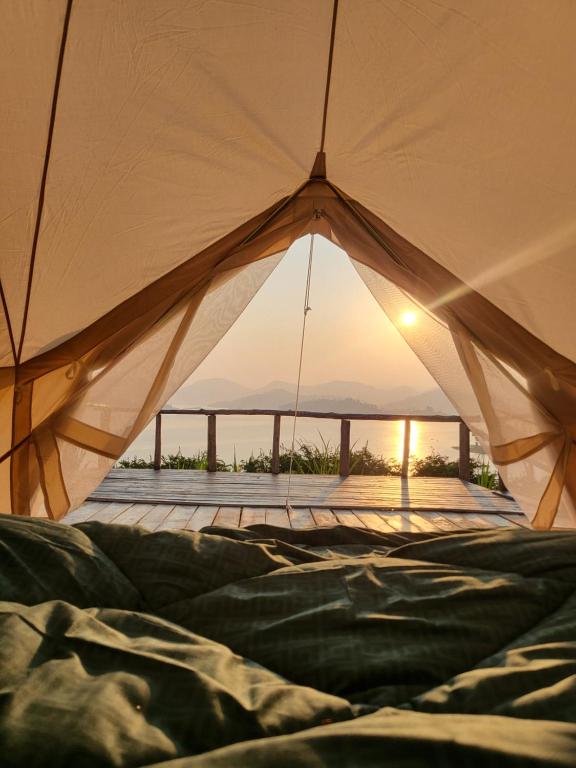 a view from inside of a tent with the sunset at Ruhondo Campsite View in Muhororo