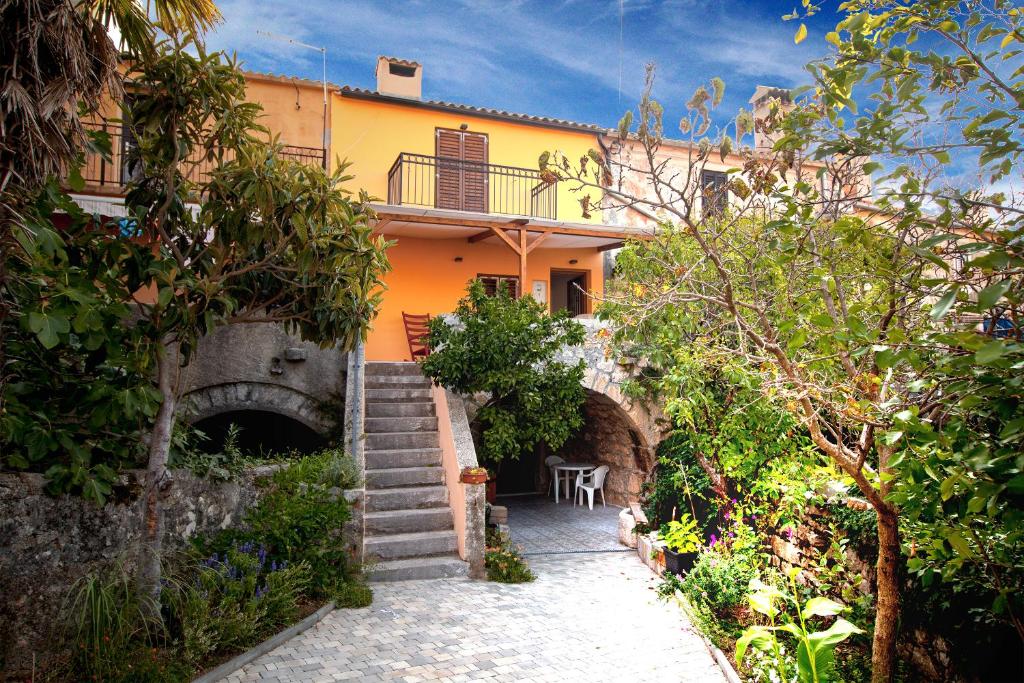 a house with stairs leading up to it at Holiday Home Kuca na Moru in Kornić