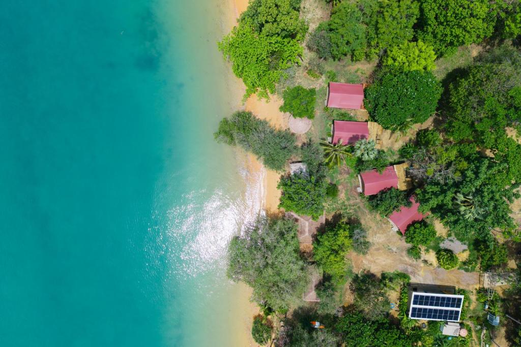 an aerial view of a beach and the ocean at The Woods Beachfront Tent Yao Noi in Ko Yao Noi