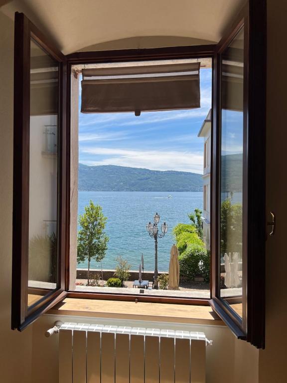 a window with a view of the water at SAGGEZZA Villa di GARGNANO in Gargnano