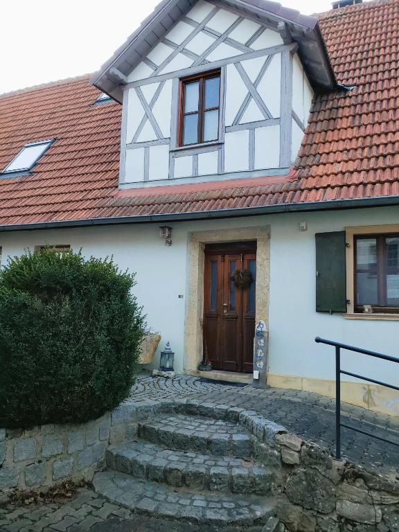 a white house with a red roof at Ferienhaus Herzogenreuth in Heiligenstadt