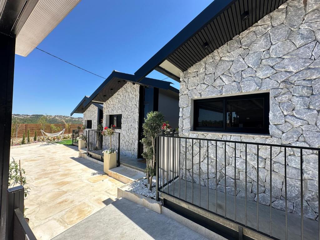 a stone house with a tv on the side of it at טריו בכרמל in Dāliyat el Karmil