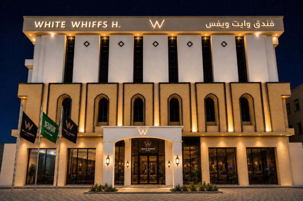 a white building with a sign on top of it at فندق وايت ويفس White Whiffs Hotel in Ad Darb