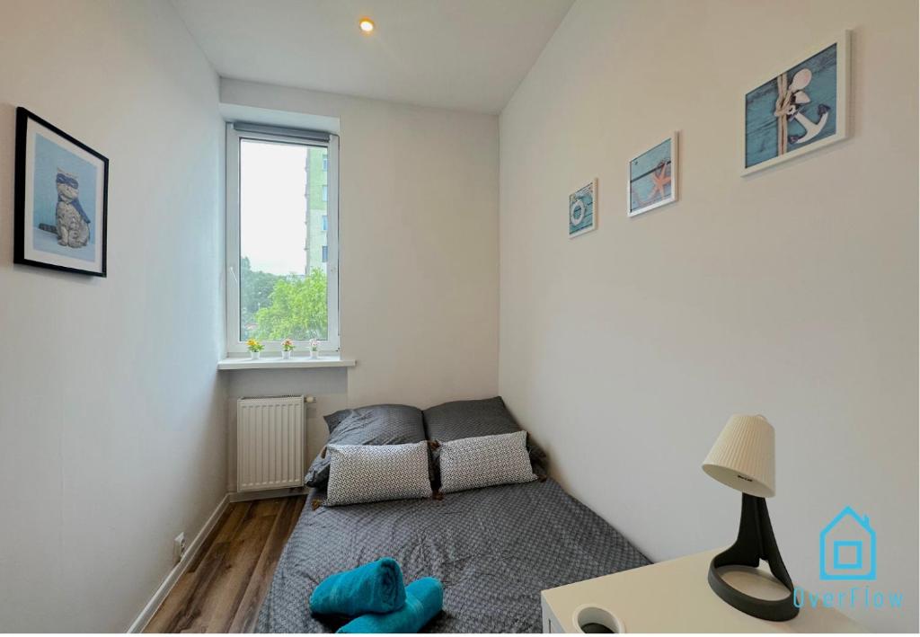 a small room with a bed and a window at Seaside Room in Gdynia