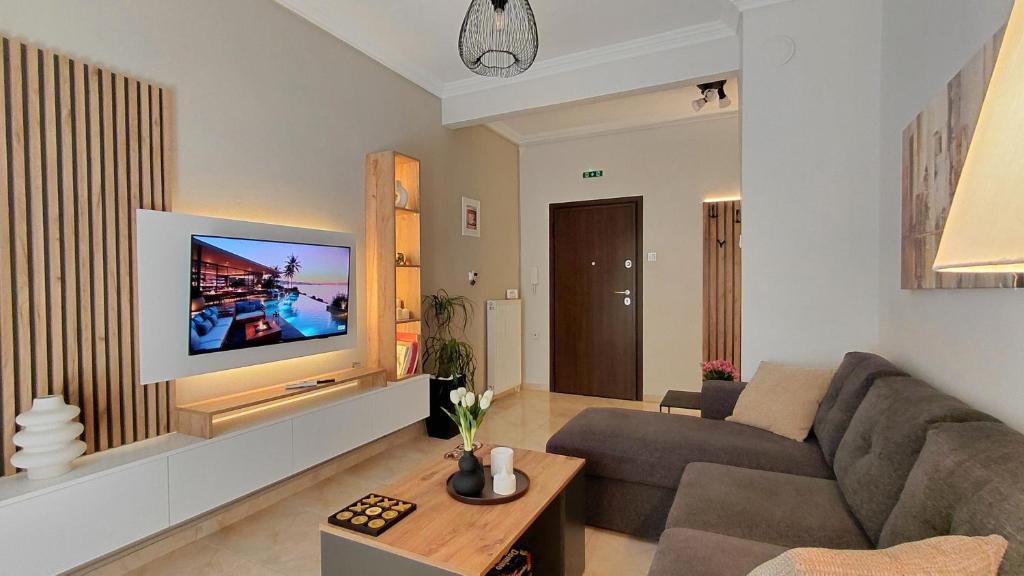 a living room with a couch and a tv at Maison Centrale - Free Private Parking - Luxury Stay in Serres Center in Serres