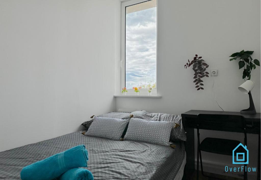 a bedroom with a bed and a window at Robot Room in Gdynia