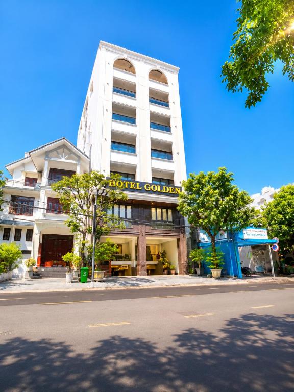 a hotel building with a sign on the front of it at Golden Hotel in Ho Chi Minh City