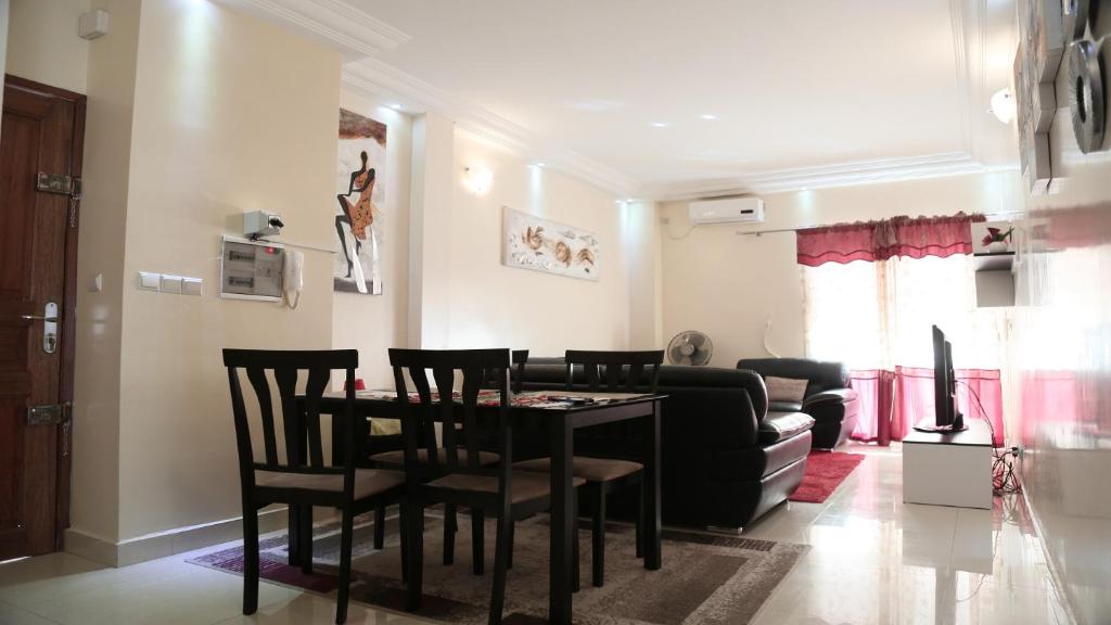 a living room with a table and chairs and a couch at Apartment 25B11 Mixta in Dakar