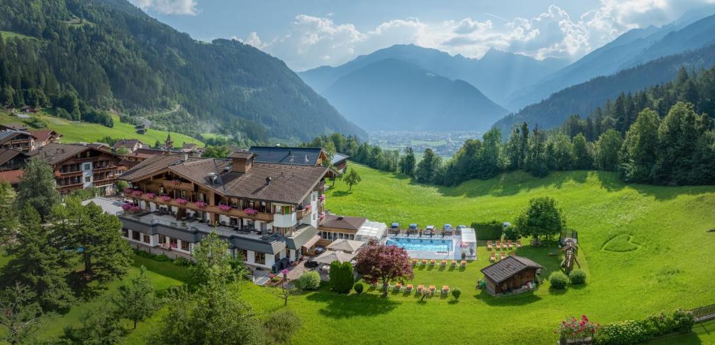 an aerial view of a resort in a green valley at Olympia-Relax-Hotel Leonhard Stock in Finkenberg