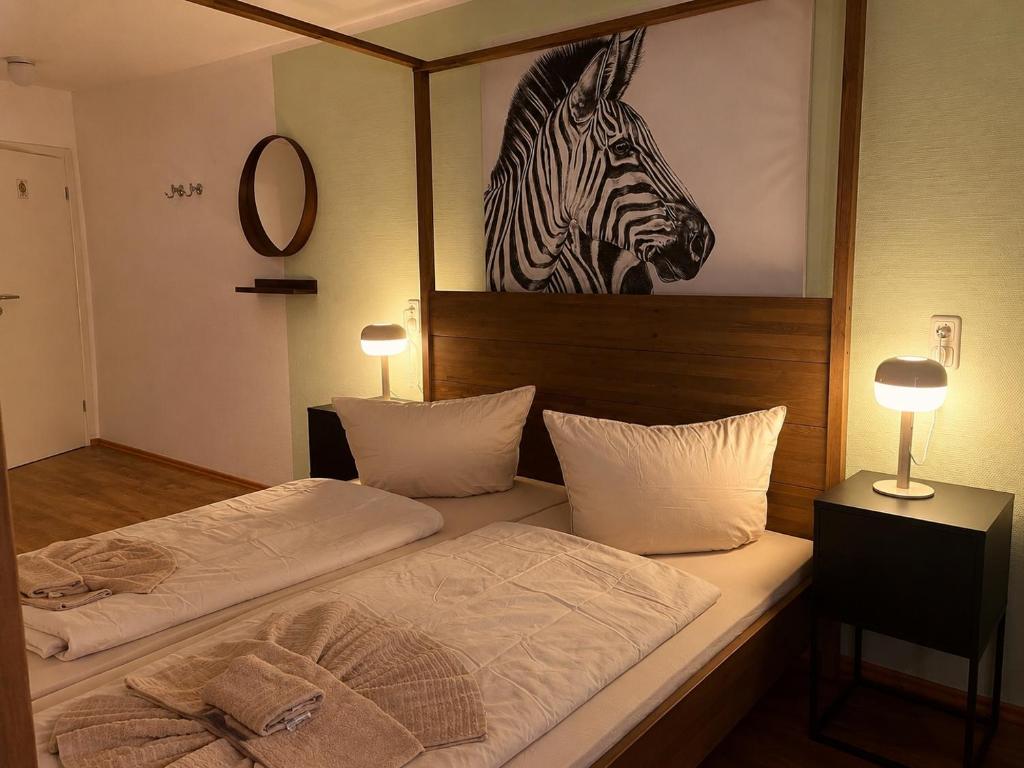 a bedroom with two beds and a picture of a zebra at Cool Apart Chemnitz in Chemnitz