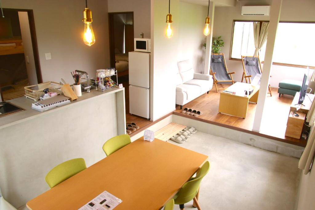 a kitchen and living room with a table and chairs at The Glow Omachi B棟 in Omachi