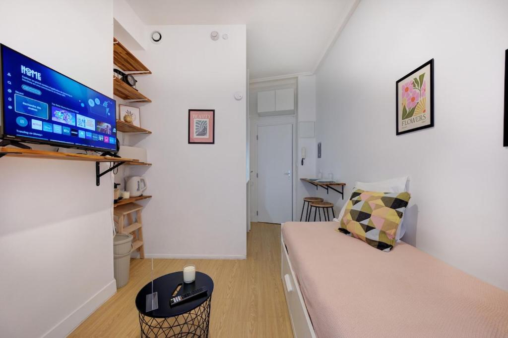 a living room with a couch and a flat screen tv at Viktor 1 - Studio Hyper Centre - Place Jean Jaurès in Tours