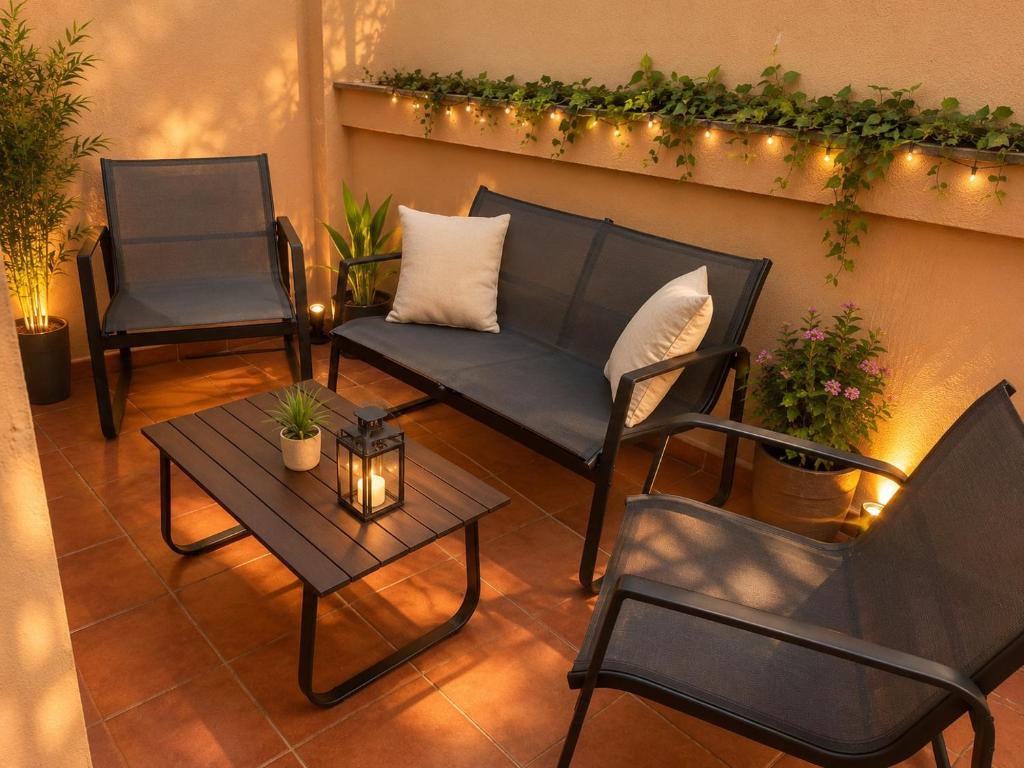 a patio with two chairs and a table and lights at Lagunas Ruidera 15 Agua y Placer in Ruidera