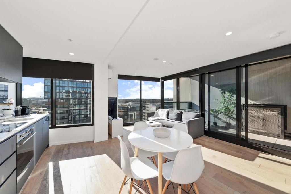 a kitchen and living room with a table and chairs at 1BR-1BR-1Car-Sleeps 4-Pool-CBD in Canberra
