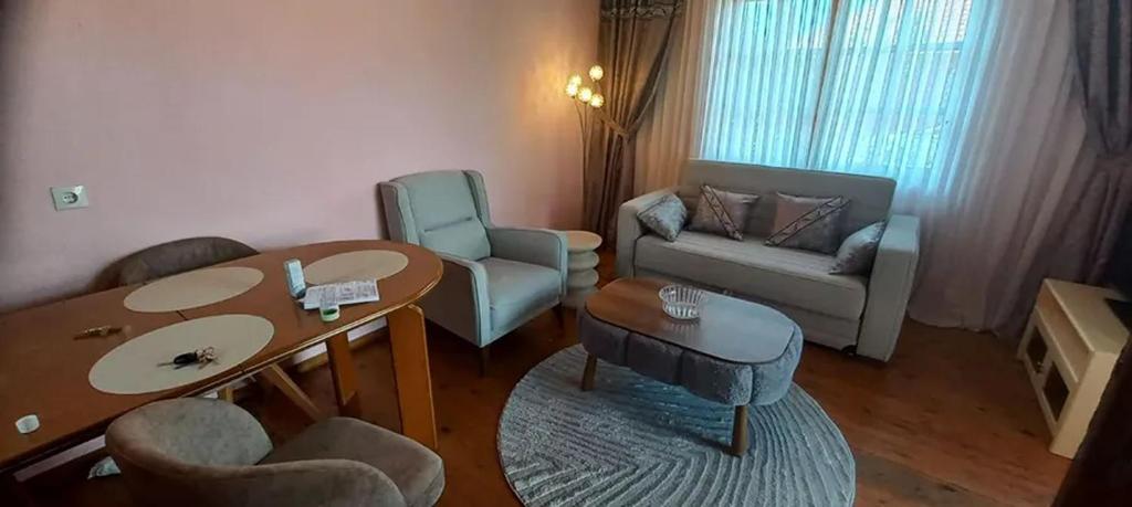 a living room with a table and a couch at Georgia's house in Maronia