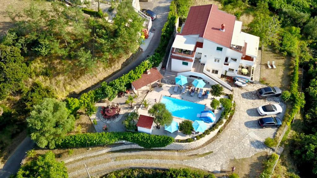an aerial view of a house with a swimming pool at Villa Saranda in Supetarska Draga