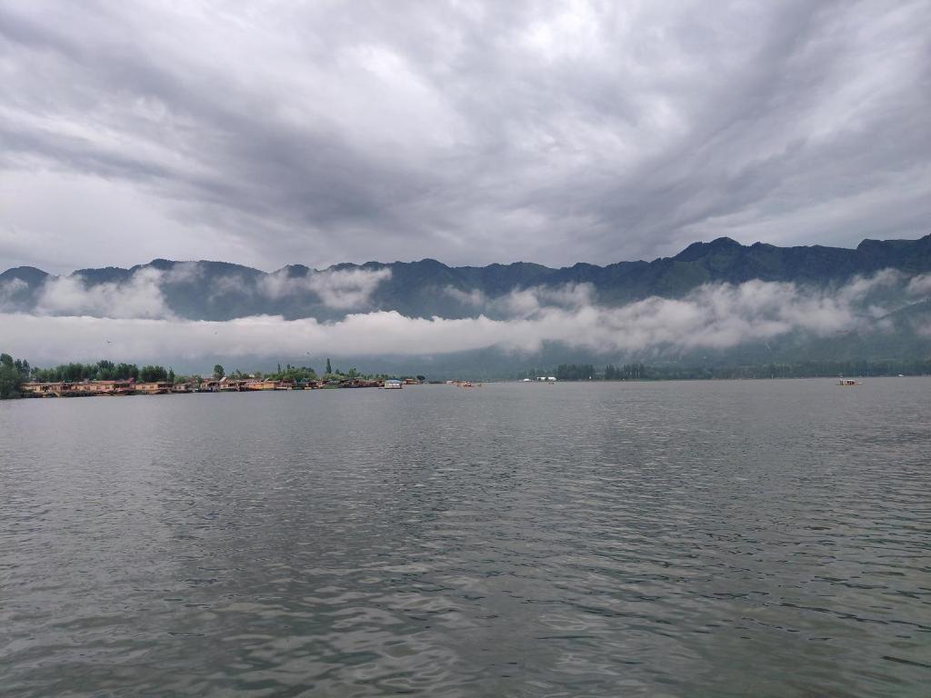 a large body of water with mountains in the background at houseboat star ruby snow view in Srinagar