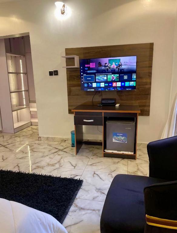 a living room with a large flat screen tv at St Kora Apartment and Shortlets in Asaba