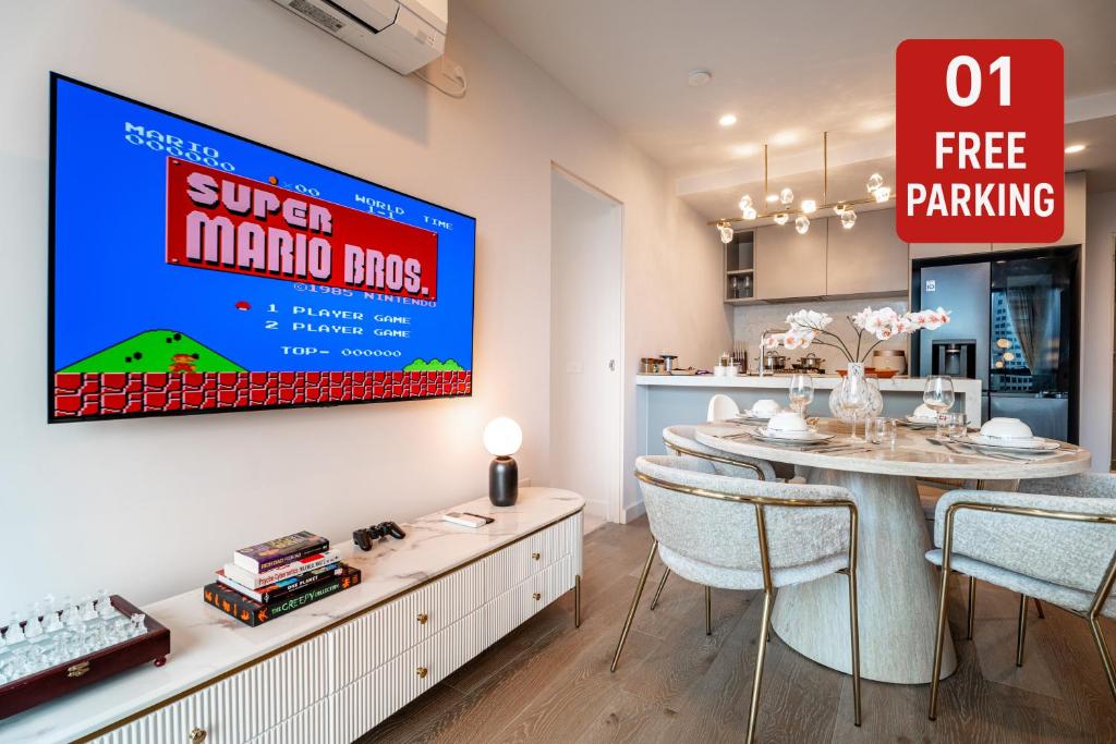 a dining room with a table and a large screen at Zen Sky Home - Super Centre with Free Car park & Pool in Melbourne