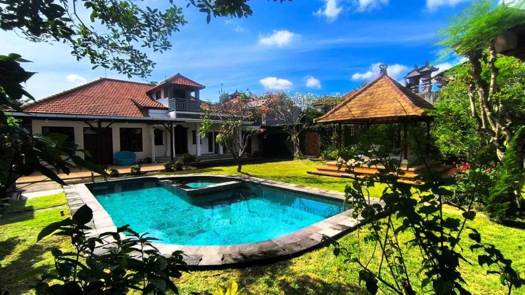 a swimming pool in the yard of a house at Eimas Hive in Kerobokan