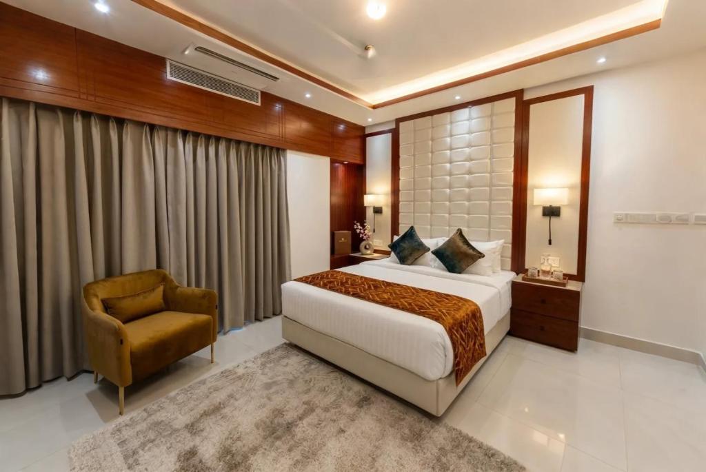 a hotel room with a bed and a chair at Royal Richmond Hotel in Dhaka