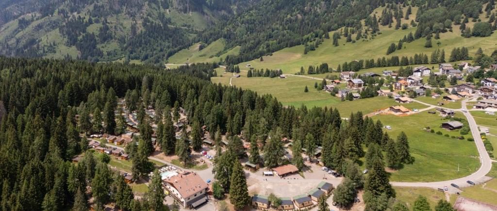 an aerial view of a village in the mountains at Club del Sole Val di Fiemme Easy Camping Village in Bellamonte