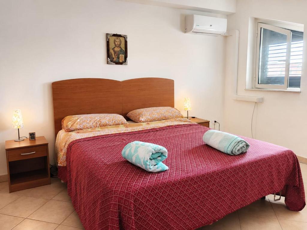a bedroom with a bed with two pillows on it at MANSARDA COSTA BIANCA - Free Parking in Realmonte
