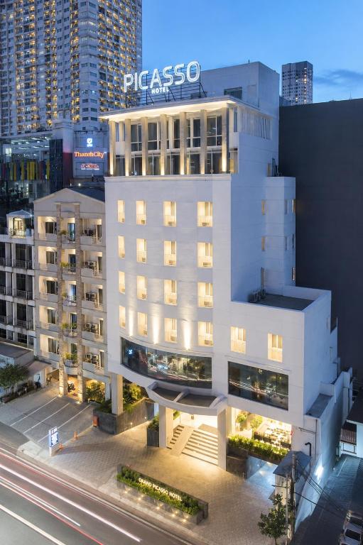 a white building with a sign on top of it at Grand Picasso Hotel in Jakarta