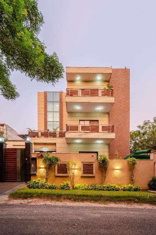 a large brick building with a balcony on it at Royal Residence 90 in Gumgaon