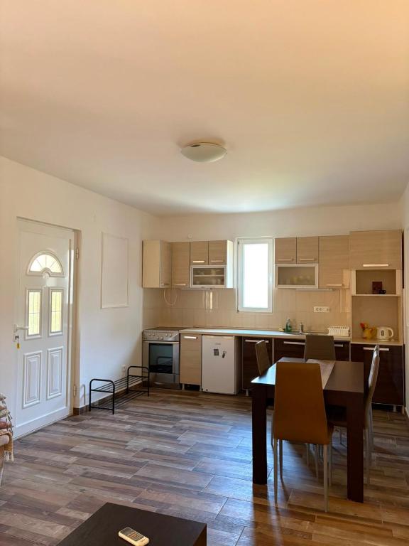 a kitchen and dining room with a table and chairs at UnaMar 2 in Prčanj